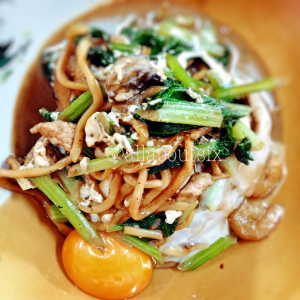 The piping hot noodles came with an egg cracked over it.